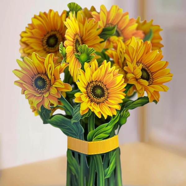 Bouquet of yellow-orange sunflowers in a green wrapped vase