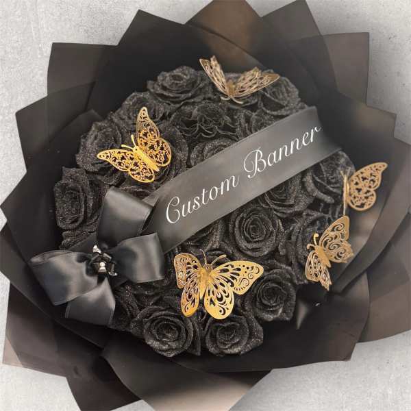Black rose bouquet with gold butterfly accents and a satin ribbon