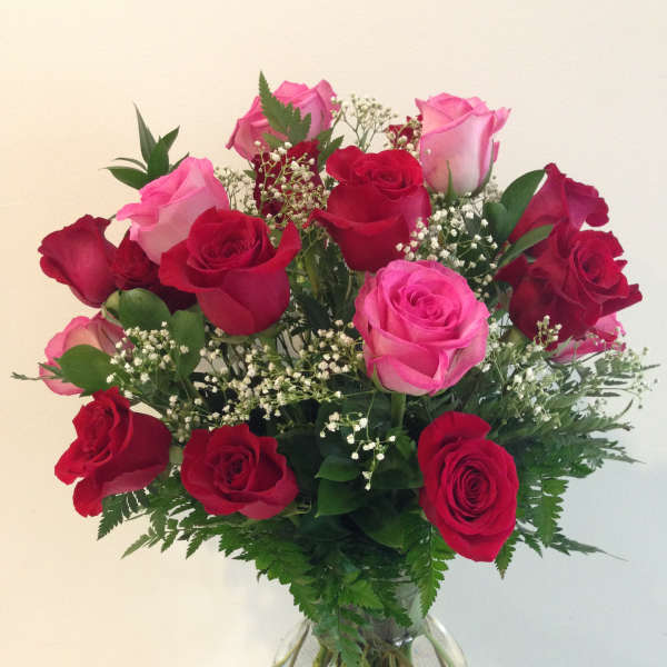 Bouquet of red and pink roses in a clear glass vase