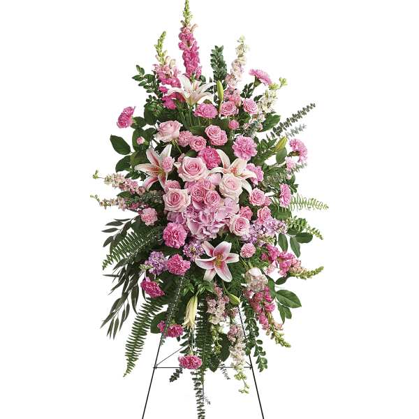 Tall pink floral standing spray with lilies and roses on an easel