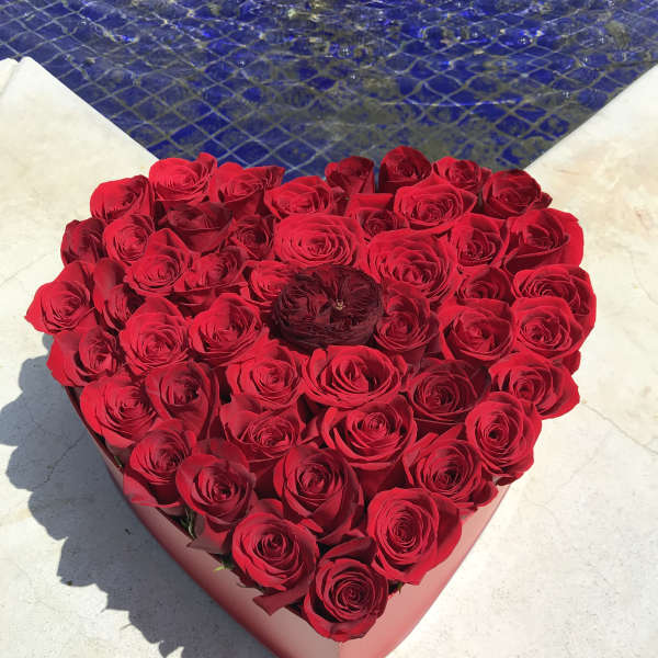 Heart-shaped box filled with red roses