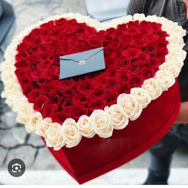 Heart-shaped box filled with red and white roses