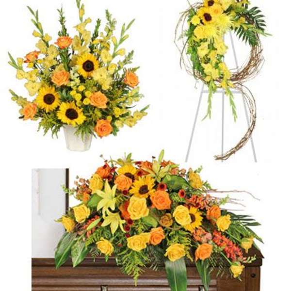 Yellow and orange floral funeral arrangements with sunflowers and roses