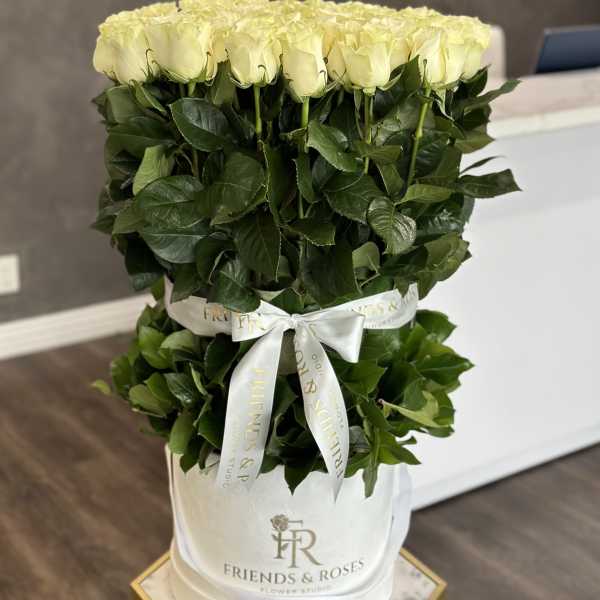 Bouquet of pale yellow roses in a white hatbox with ribbon