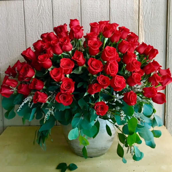 Large bouquet of red roses in a white vase