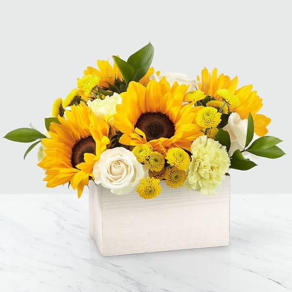 Sunflowers and white roses in a white wooden box