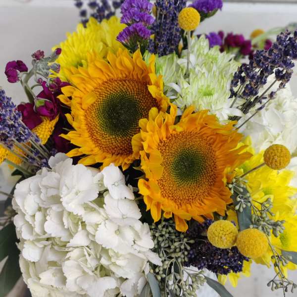 Bouquet of sunflowers, white hydrangea, and purple filler flowers