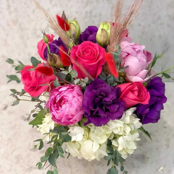 Bouquet of pink and purple roses with white hydrangea
