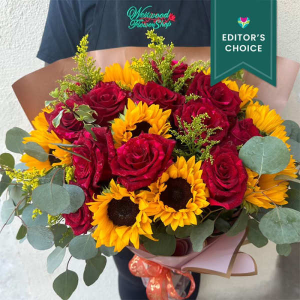 Bouquet of red roses and yellow sunflowers with eucalyptus