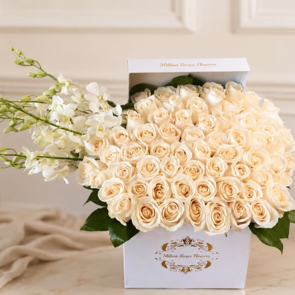 Cream roses in a white gift box with white orchids