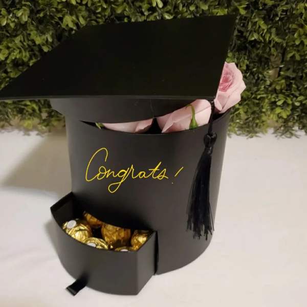 Black gift box with pink roses and chocolates
