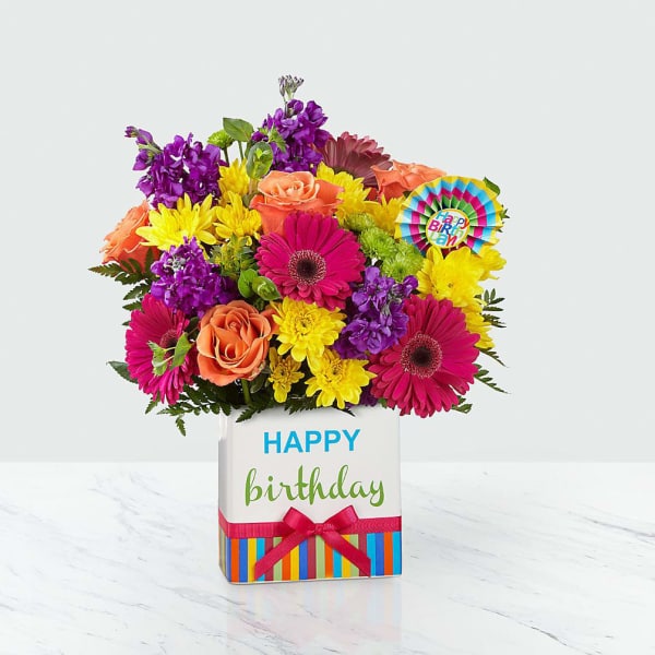Colorful bouquet in a birthday gift box with a Happy Birthday tag