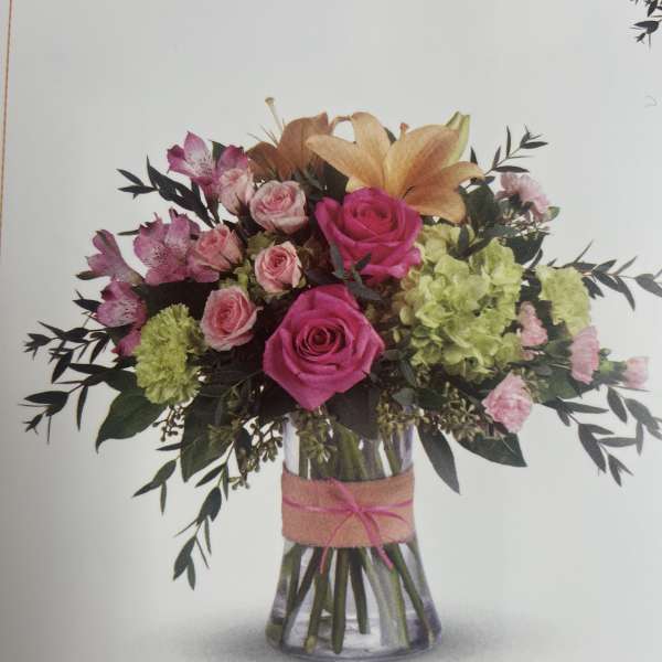 Bouquet of pink and peach flowers in a glass vase