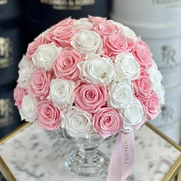 Pink and white rose bouquet in a clear glass vase