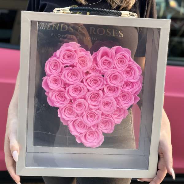 Heart-shaped frame filled with pink roses