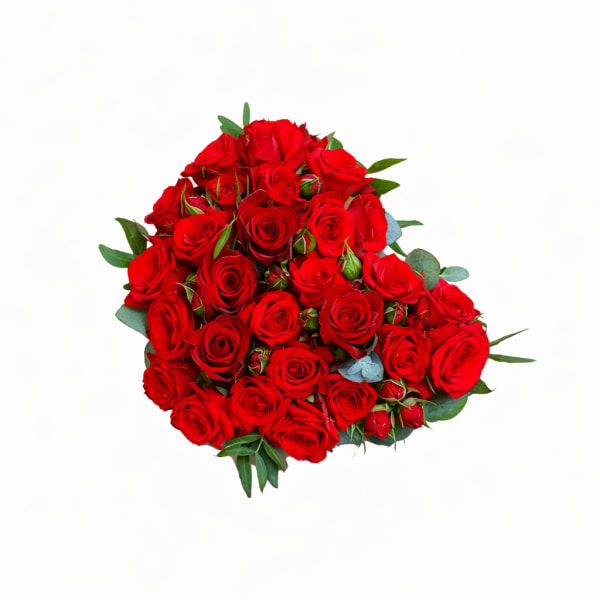 Bouquet of red roses with scattered greenery on a white background