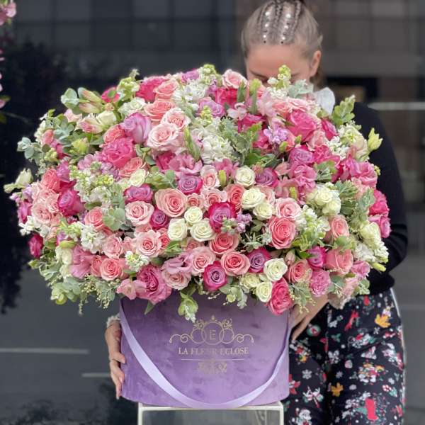 Large pink and white rose bouquet in a purple box