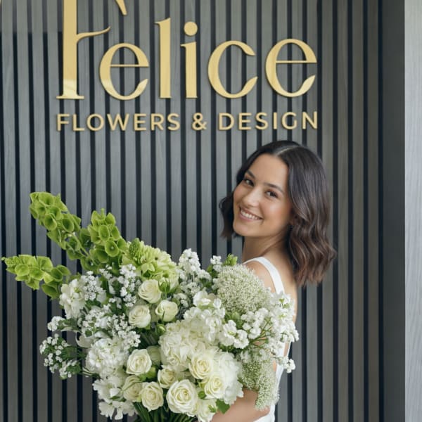 Bride holding a large white and green bouquet