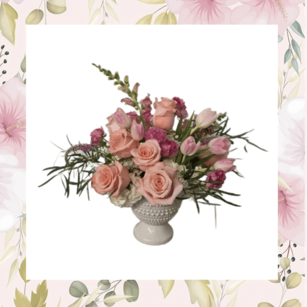 Pink roses and tulips arranged in a white pedestal vase