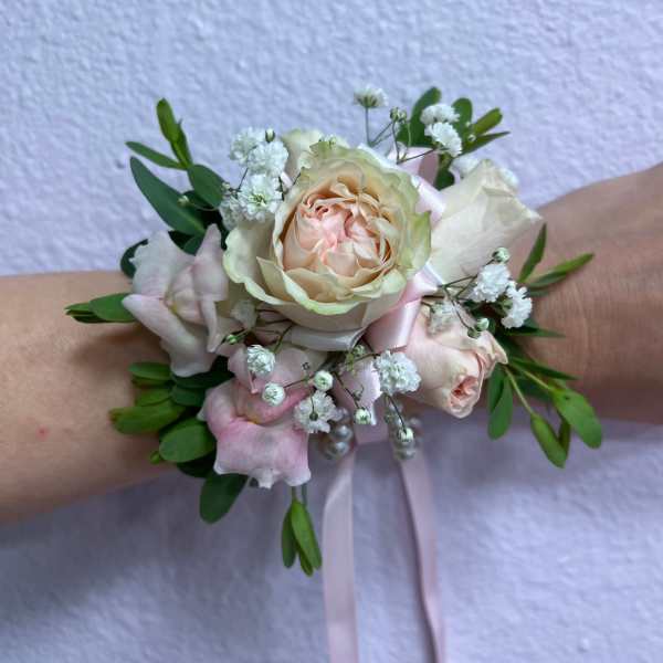 Pastel rose wrist corsage with baby's breath and ribbon