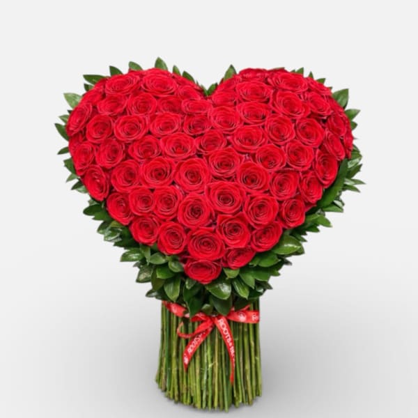 Heart-shaped bouquet of red roses with a ribbon-wrapped stem bundle