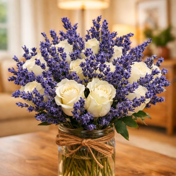 White roses and purple lavender in a glass jar vase