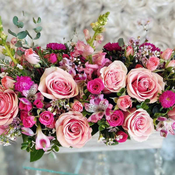 Pink rose bouquet with small magenta flowers and mixed greenery