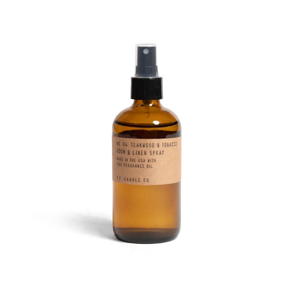 Amber spray bottle labeled teakwood and tobacco room and linen spray