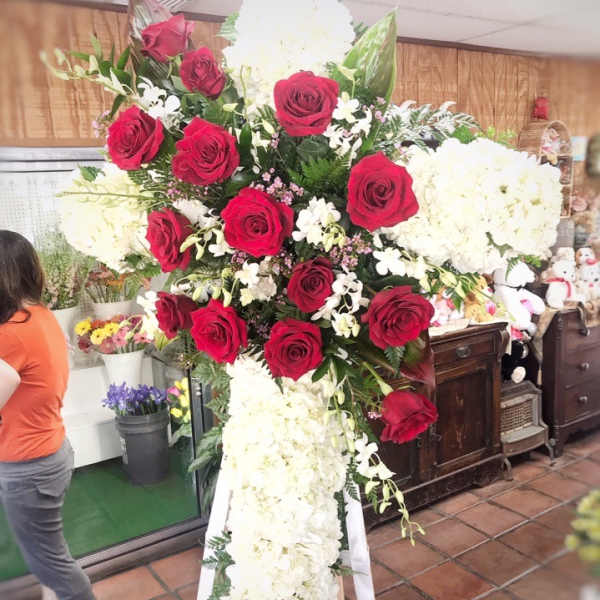 Standing floral cross with red roses and white blooms