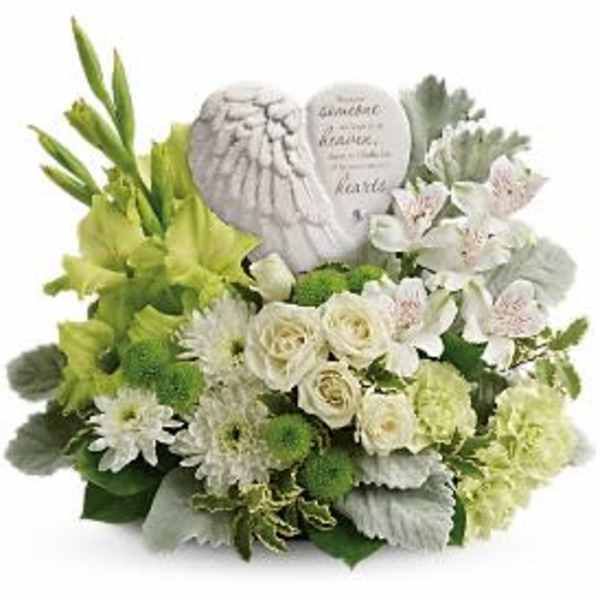 White and green floral arrangement with two memorial stones