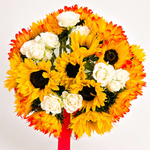 Bouquet of yellow sunflowers and white roses with a red ribbon