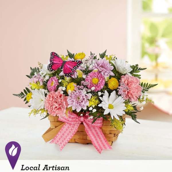 Pink and white mixed flower basket with a butterfly decoration