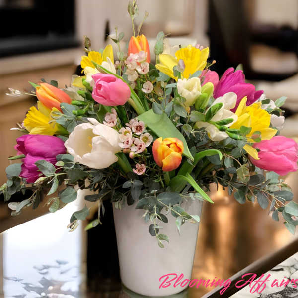 Colorful tulip bouquet in a white vase