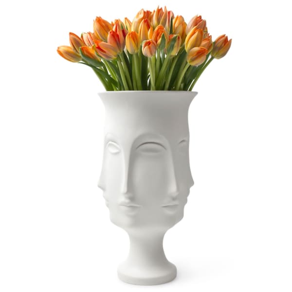 Orange and yellow tulips in a white sculptural vase