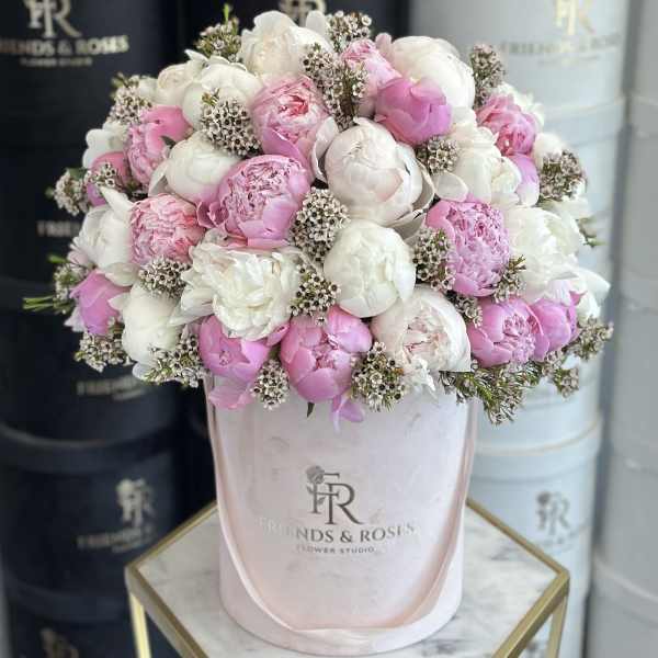 Pink and white peonies in a pale pink hat box
