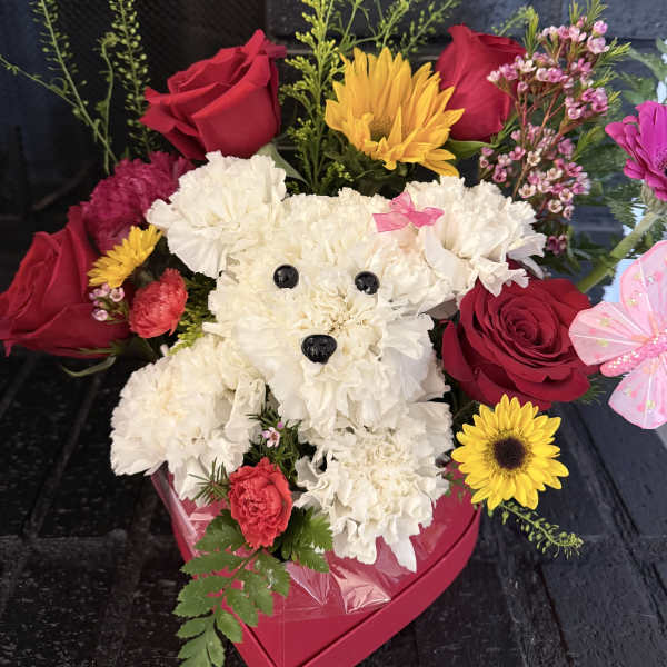 White teddy bear made of flowers with red roses and yellow blooms