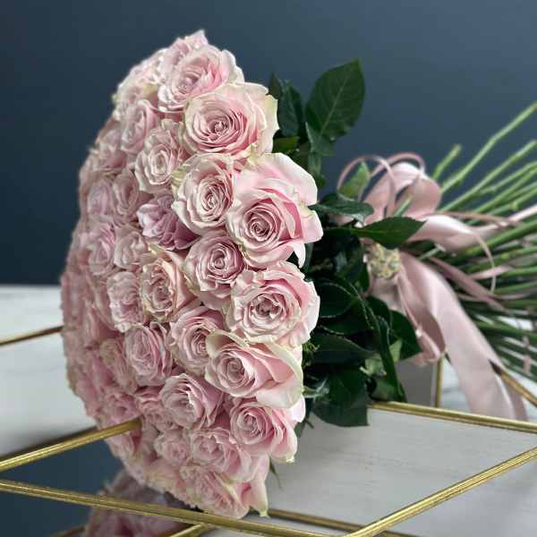Large bouquet of pale pink roses with ribbon wrap