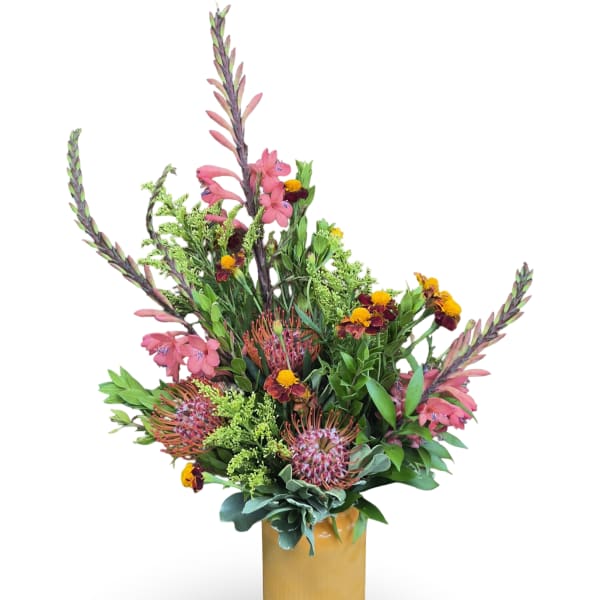 Tall mixed bouquet in a gold vase with pink and orange flowers