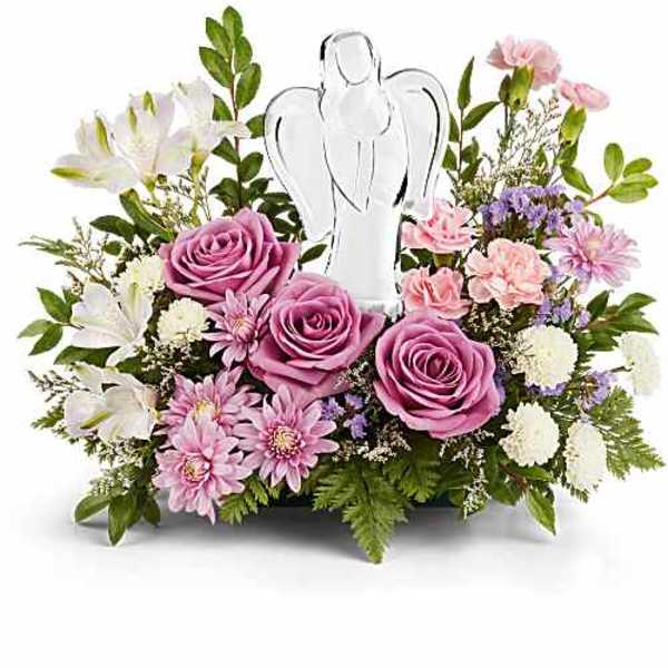 Lavender and pink flower arrangement with roses and a clear angel figurine in a low container