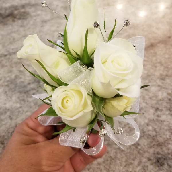 Small white rose corsage with ribbon and silver accents