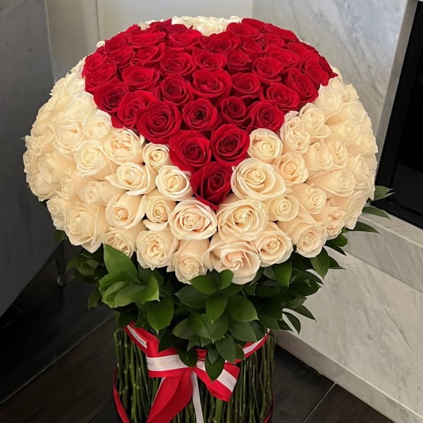 Large bouquet of red and cream roses in a round arrangement