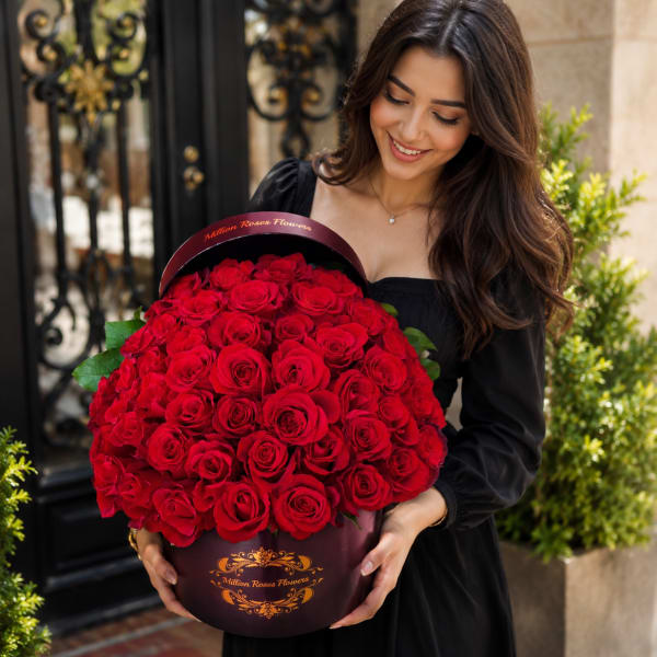 RED ROSES IN A BLACK ROUND BOX