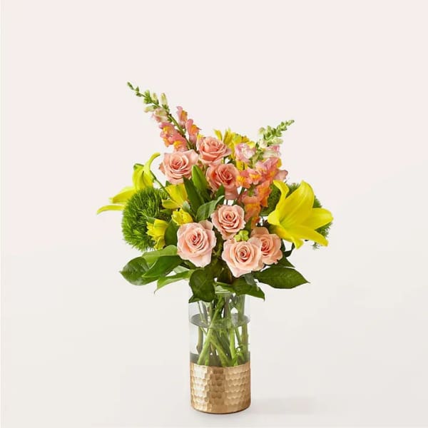 Pink roses and yellow lilies in a glass vase