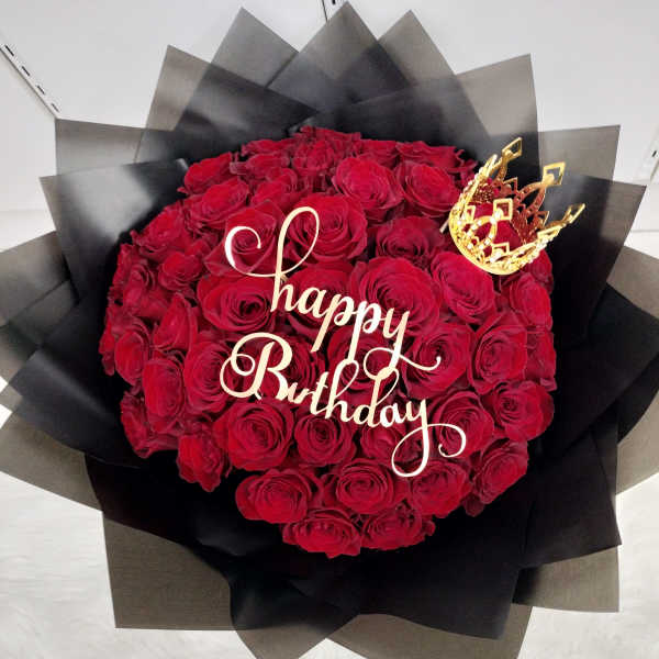 Red rose bouquet with a gold "Happy Birthday" topper and crown