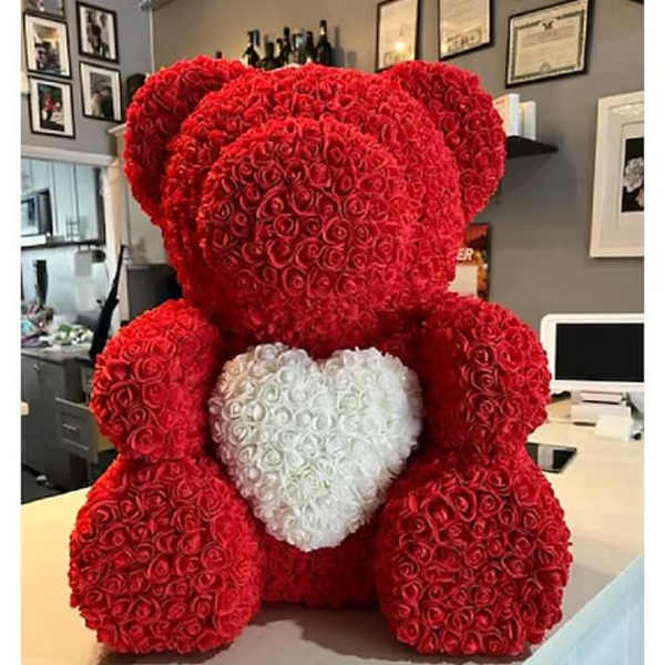 Large red rose teddy bear with a white heart on its chest