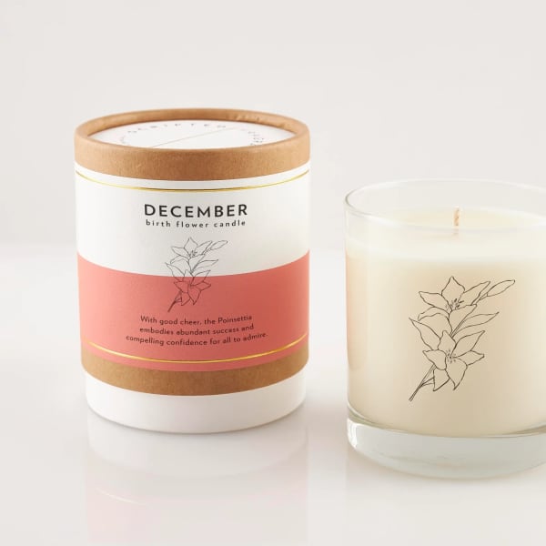 Two December birth flower candles, one in a box and one in a glass jar