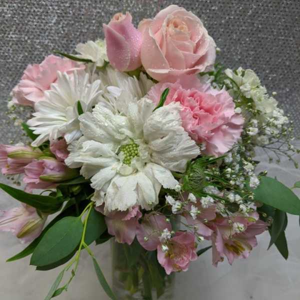 Pink and white bouquet in a clear glass vase
