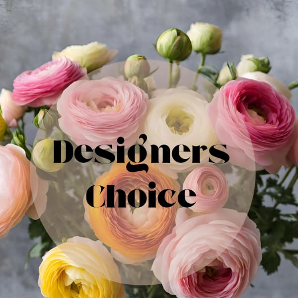Bouquet of pink, white, and yellow ranunculus in a glass vase