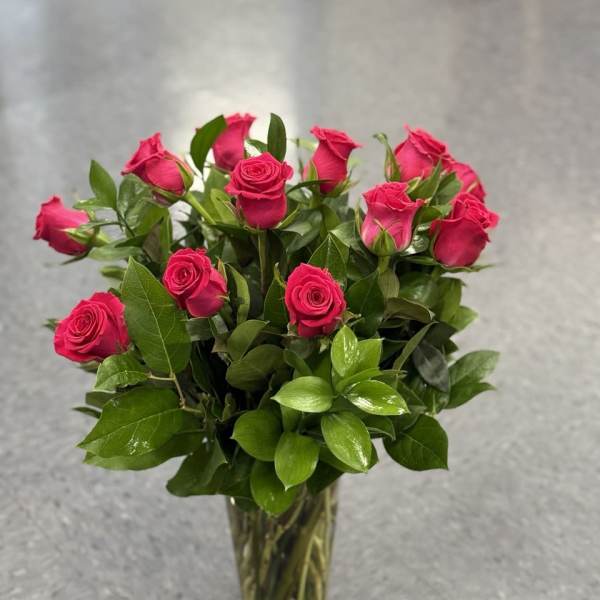 Pink roses arranged in a clear glass vase