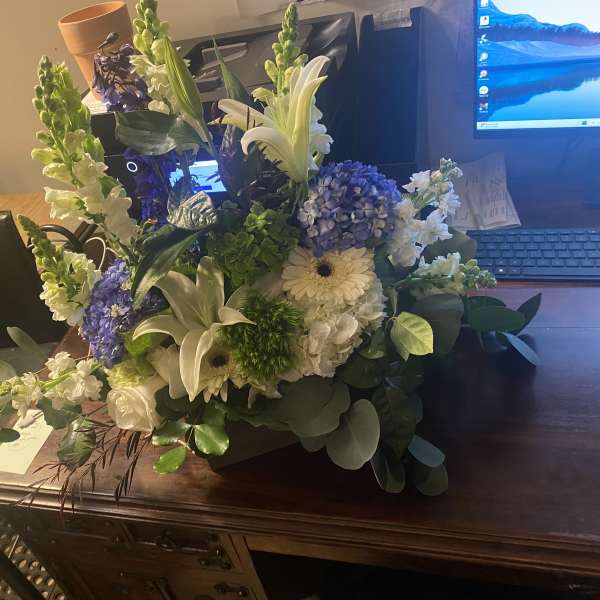 Mixed bouquet with white lilies, blue hydrangea, and white daisies